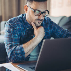 a man looking for a job on the computer