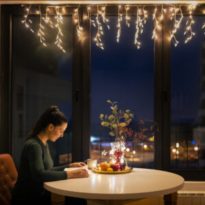 woman reading by herself with Christmas festivities